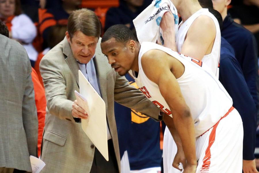 Head coach Tim Floyd discusses a play with Senior forward Vince Hunter.