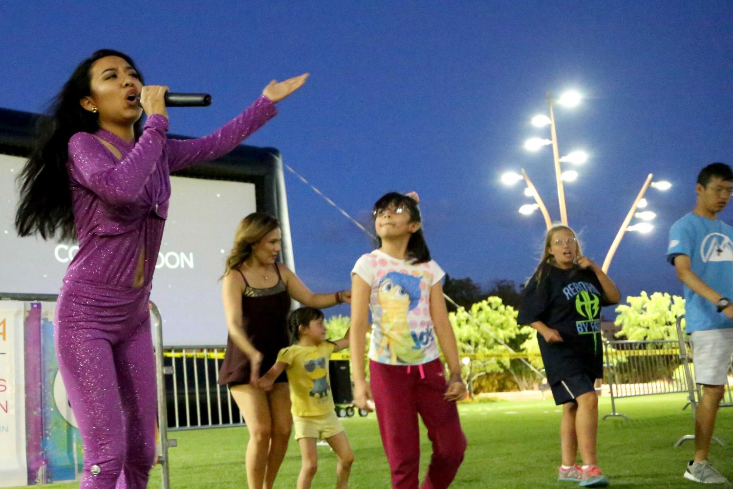 The audience join the Selena impersonator up in the front to dance before the movie. 