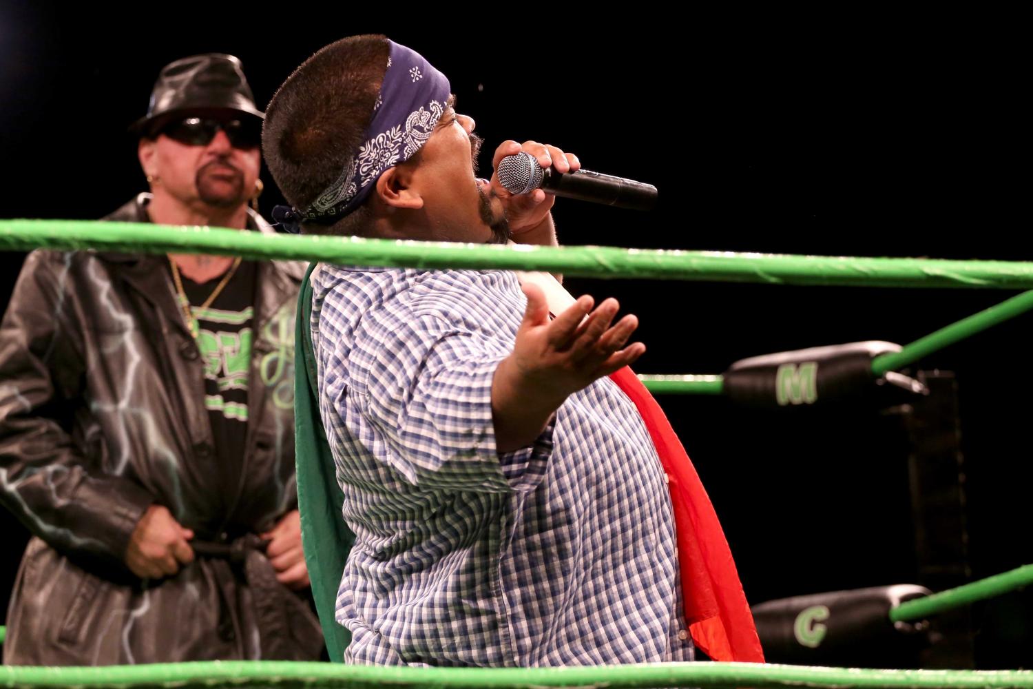 The Chola yells out "Orale" as he is being introduced to the crowd.