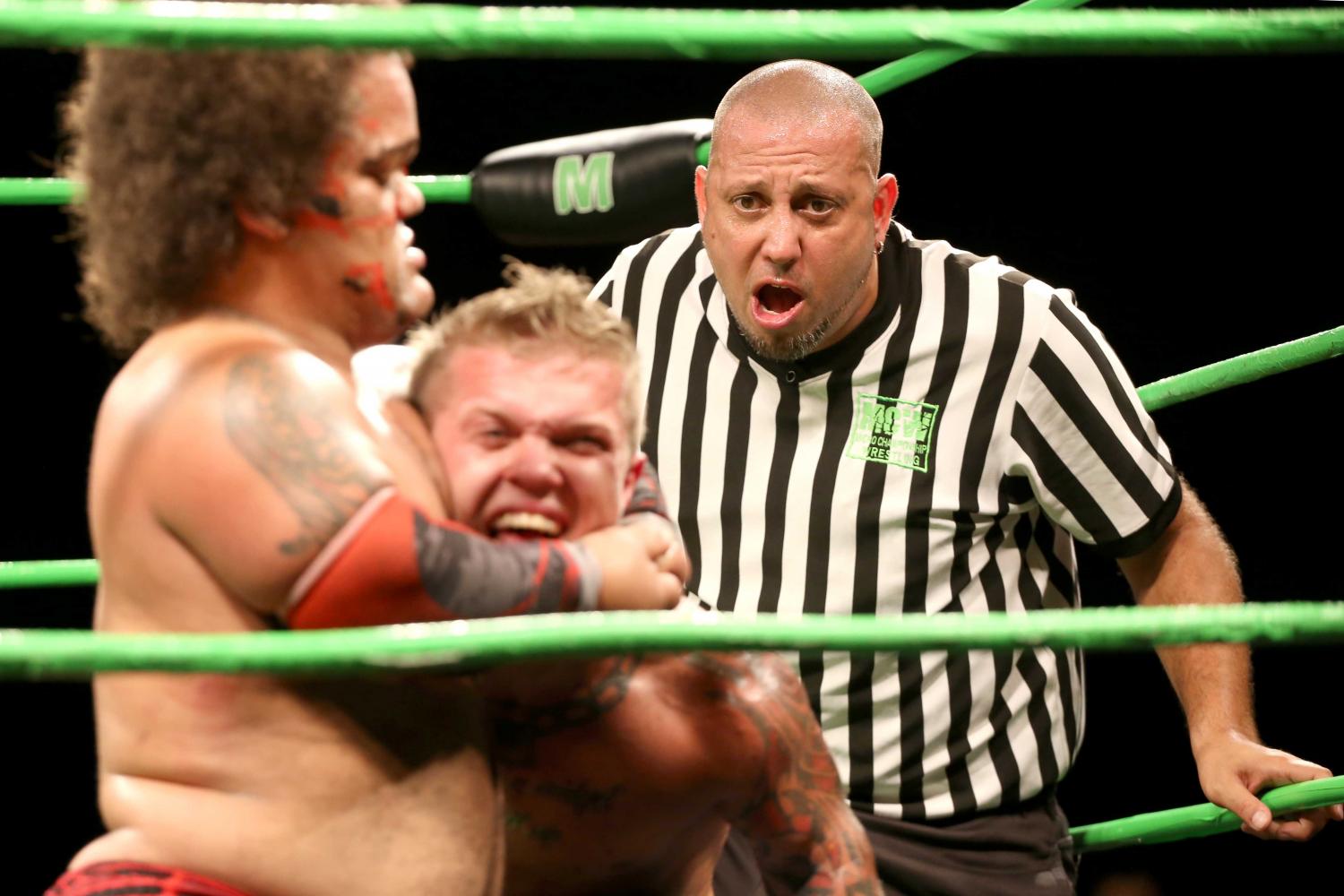 The referee look shocked as he watched King Samoa hold MCW champion Cowboy Kid Quick in a head lock.