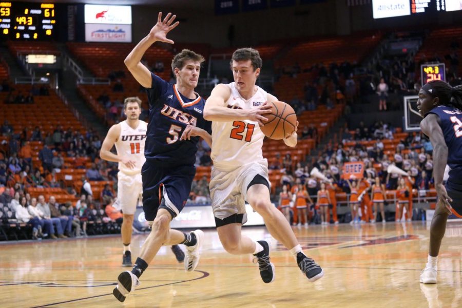 Trey Touchet dribbles past the defender as he draws the foul. 