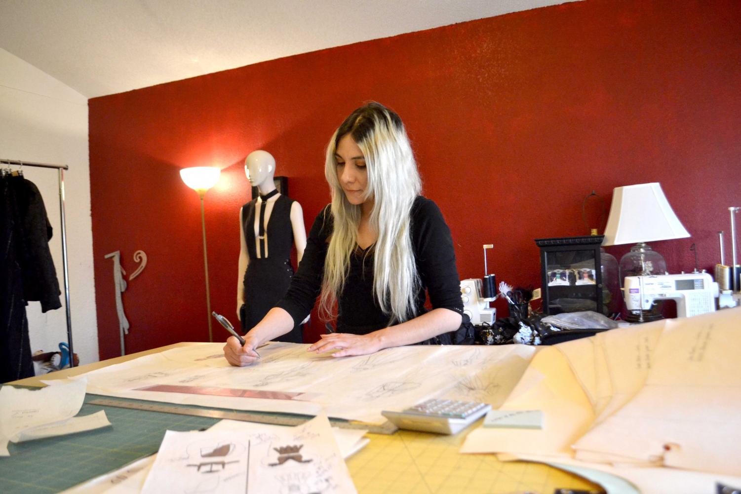 Lizette Arenas, owner of Obscurity Designs, works on one of her most recent clothing designs. 