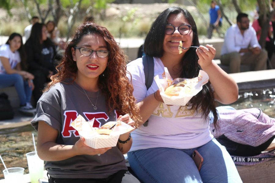 Junior criminal justice major Justine Valles and freshman nursing major Monika Ramirez enjoy the free food that SGA was offering to the first 250 students at the first Miner Fest on Wednesday, April 18 at Centennial Plaza. 