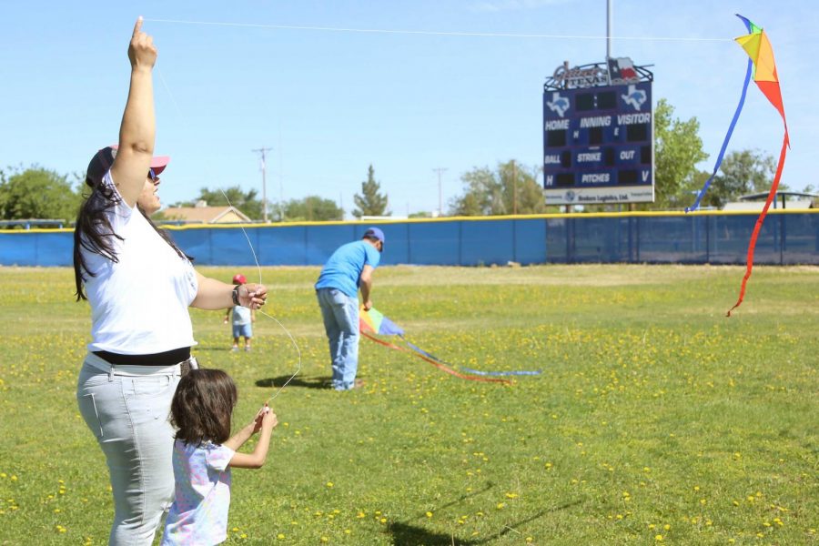 Voices United Executive Director Ambar M. Gutierrez flies a kite with her daughter at the first annual Kite Festival on Saturday, May 19, at Ernie Rascon Memorial Park. 