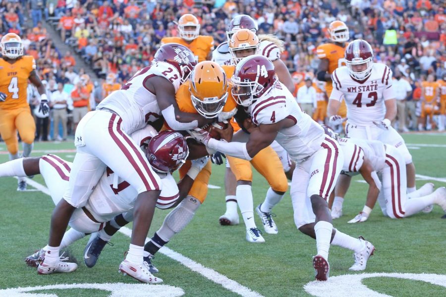 Quarterback Kai Locksley gets sandwhiched between NMSU junior defensive back DeMarcus Owens and senior defensive back Shamad Lomax.