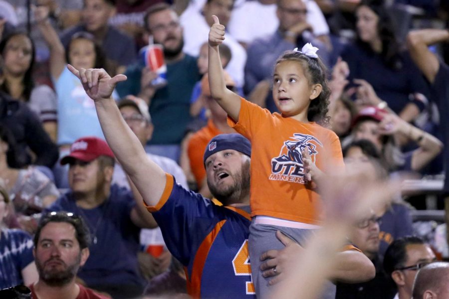 Fans celebrate with the UTEP cheerleaders as they throw up their picks up.