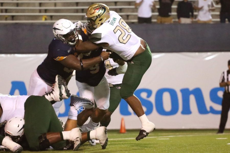 UAB's sophomore running back Spencer Brown is tackled in the backfield. 