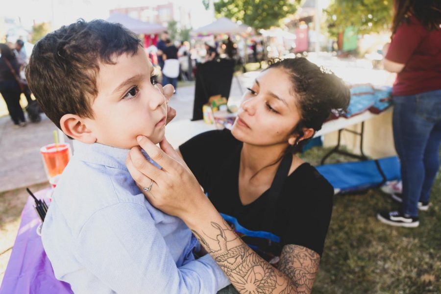 The Society of Woman Engineers paint kids faces at the first annual Noche de Calaveras Parade hosted by the El Paso Museum of Art. 