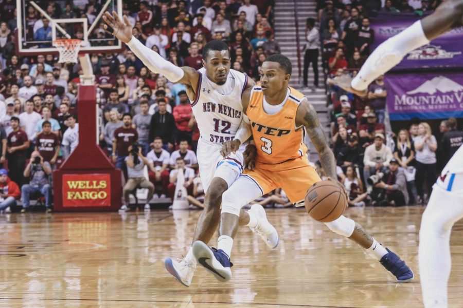 Sophomore guard Evan Gilyard looks to drive past the NMSU defender at a game against the Aggies on Friday night, Nov. 9 at NMSU. 