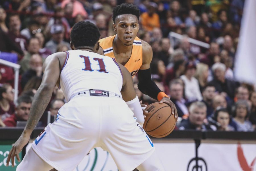 Freshman guard Jordan Lathon looks to drive past the defender.