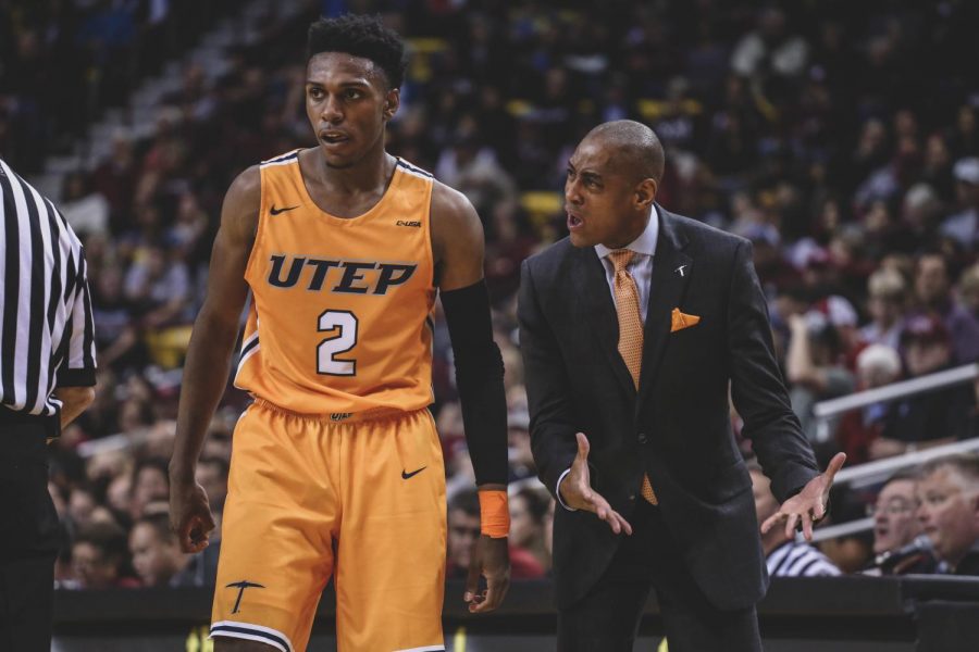 Head coach Rodney Terry talks to freshman guard Jordan Lathon about attacking the Aggies defense.   