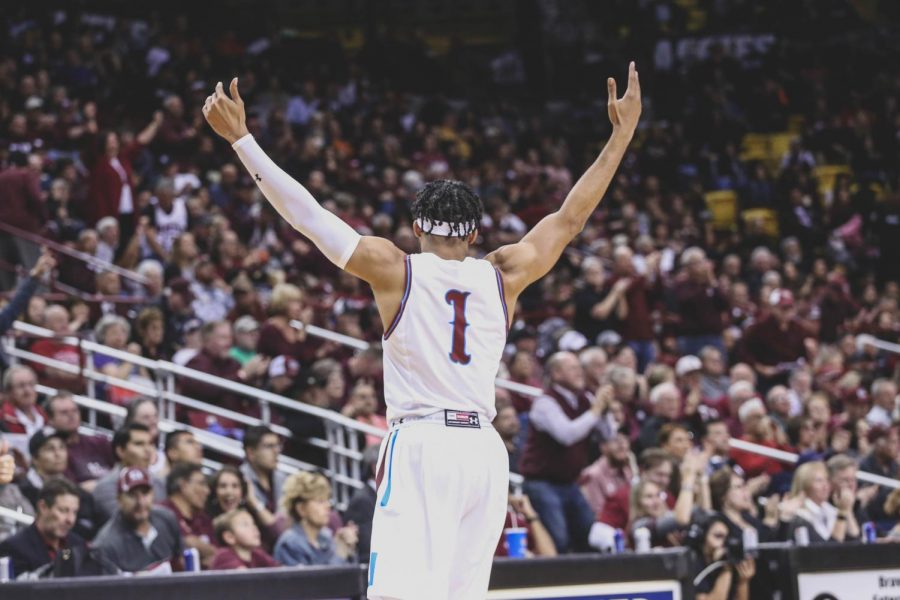 NMSU junior guard Shunn Buchanan celebrates as the Aggies beat the Miners 91-66. 