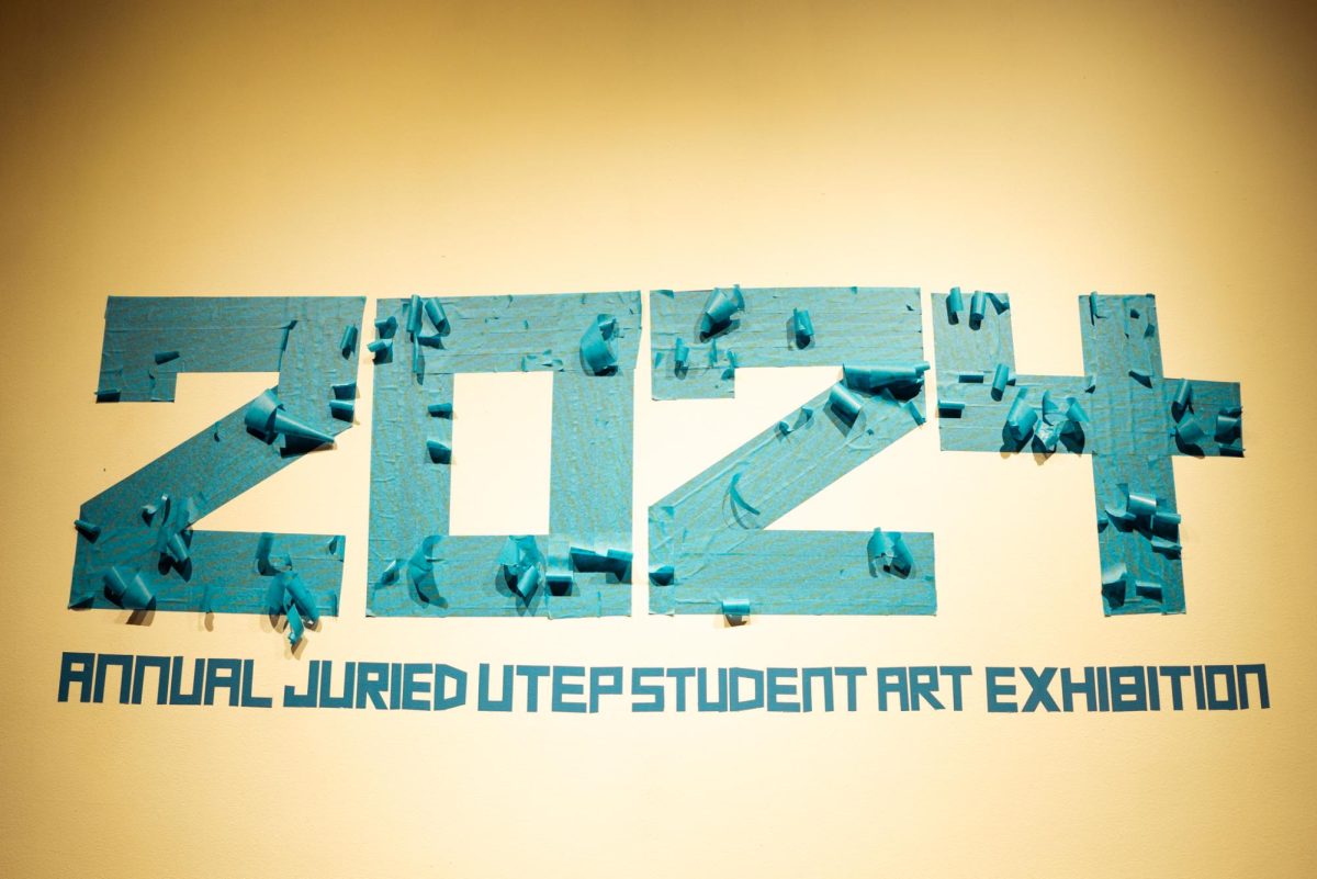 The 2024 Annual Juried UTEP Student Art Exhibition sign was made with blue tape, which is commonly used when painting.