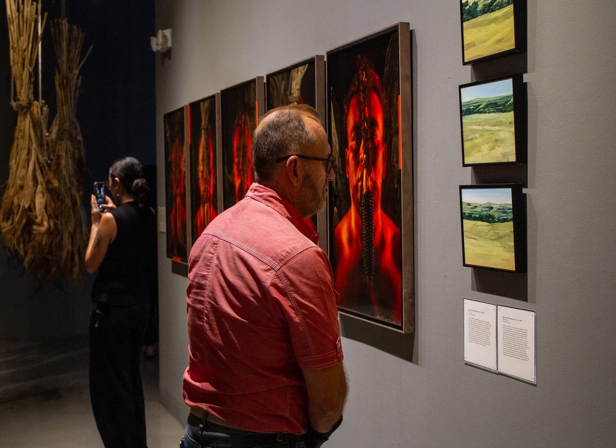 Attendee admires work being displayed at the gallery.