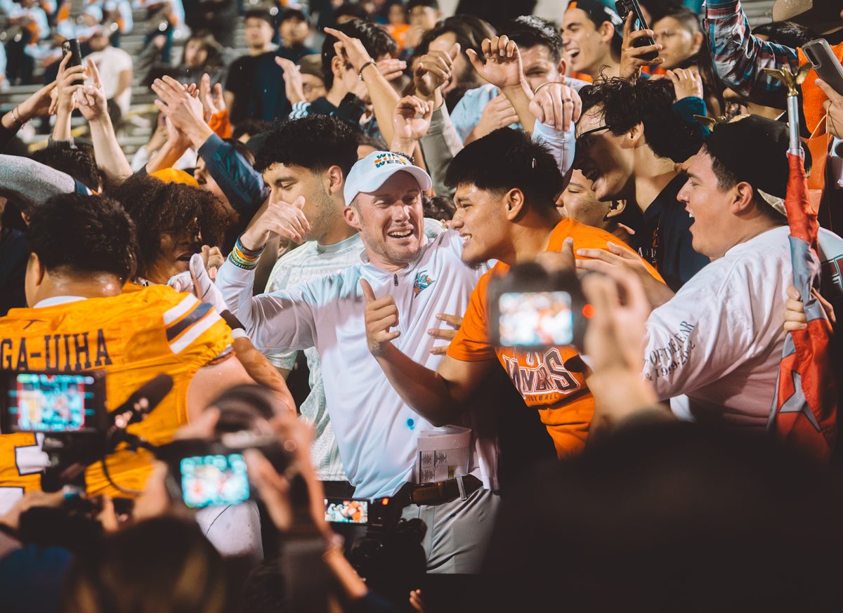 Head coach Scotty Walden celebrating in the stands with the fans the victory against FIU Wednesday Oct. 17 at the Sun Bowl.