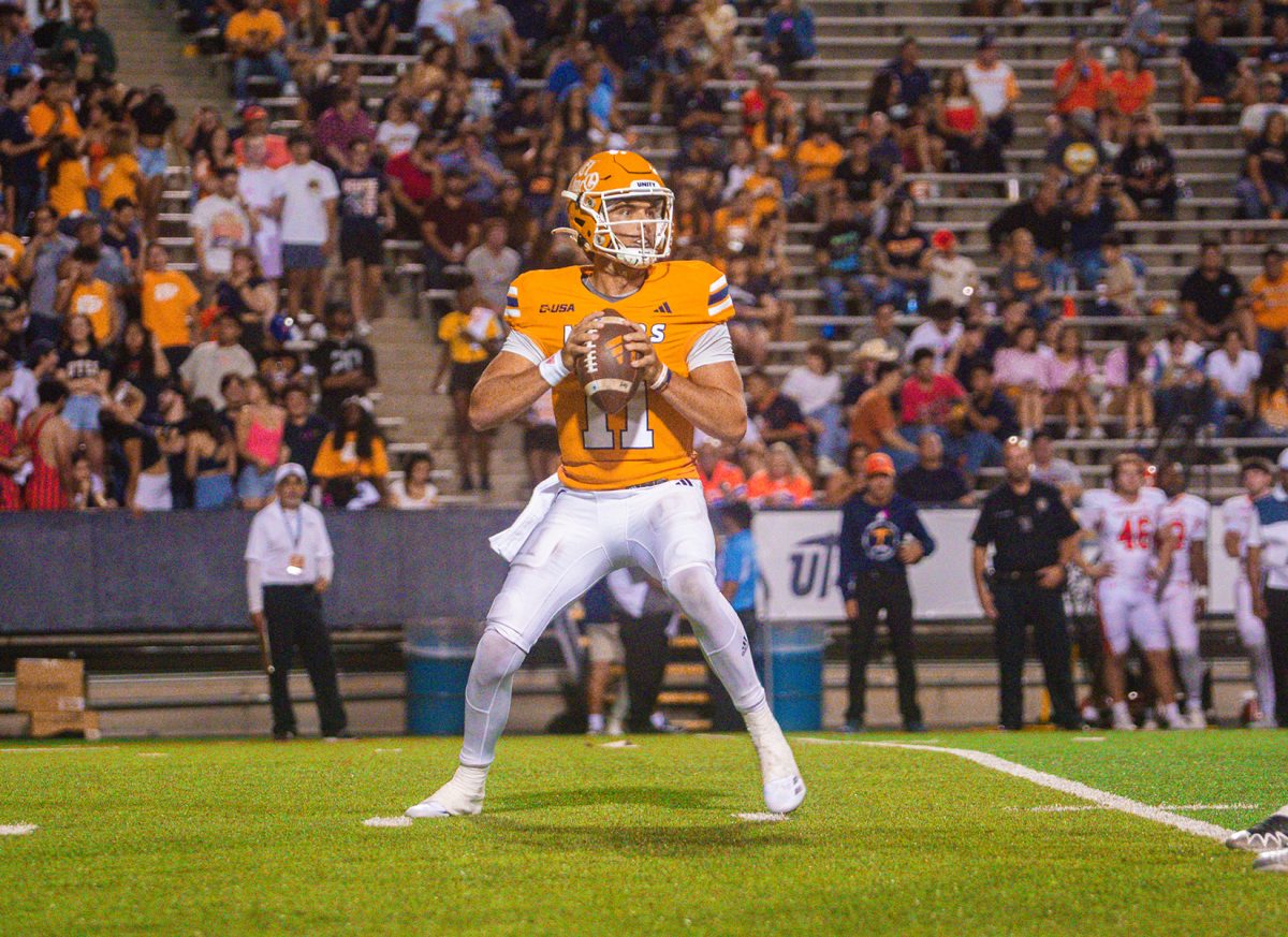 Quarterback Cade McConnell looking for an open teammate to throw a pass.