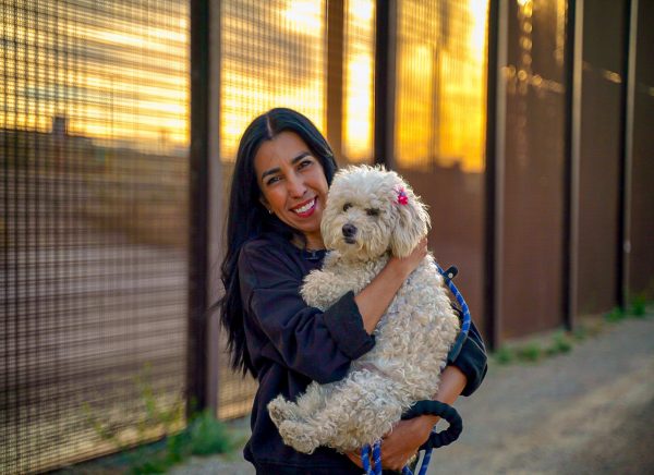 Ruby Montana, organizer of foster-based Bridge Pup Rescue, with one of the foster pups at the U.S. Mexico Border.