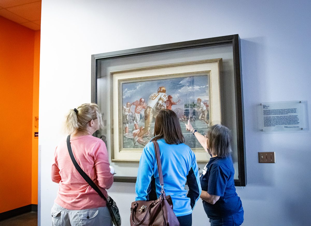 Viewers admire Tom Lea's The Turning Point, captivated by its portrayal of the Texas Western Miners' comeback against the University of Utah.