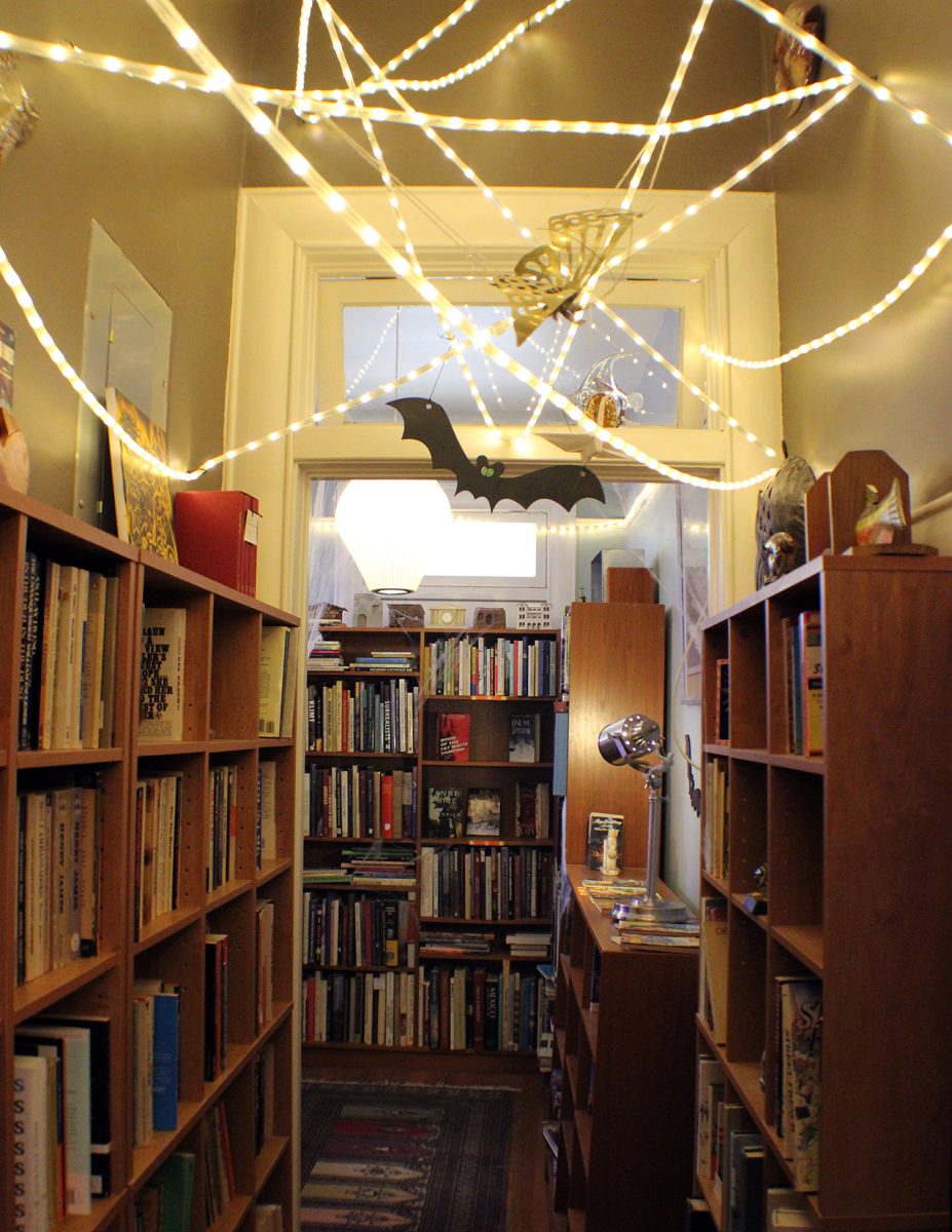 The Little Bookshop of Horrors hallway filled with Halloween decorations and some fan favorite horror books.