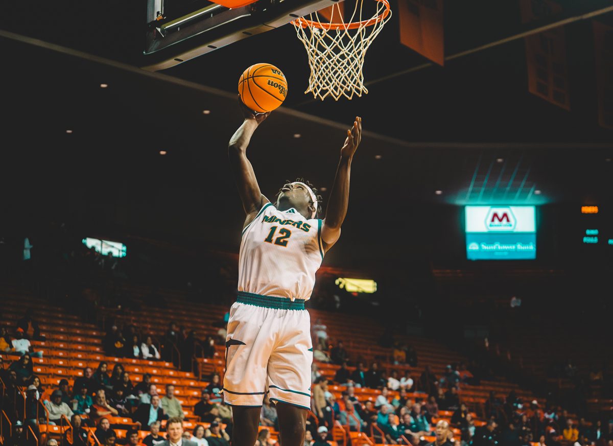 Guard Ahamad Bynum jumps into the air in attempt to dunk the ball during a game against Sul Ross State.