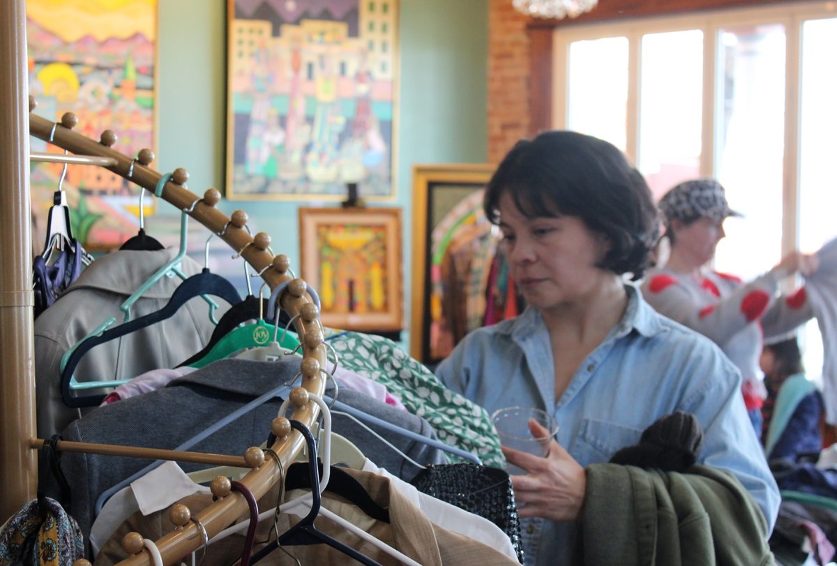 Participants of the Sunset Parlor clothing swap browse through the second-hand clothing selection.