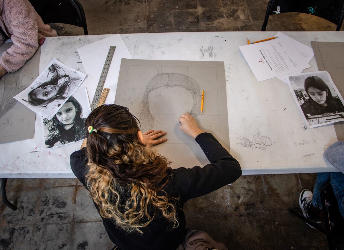 Kids at the Creative Center learn how to sketch out self-portraits.