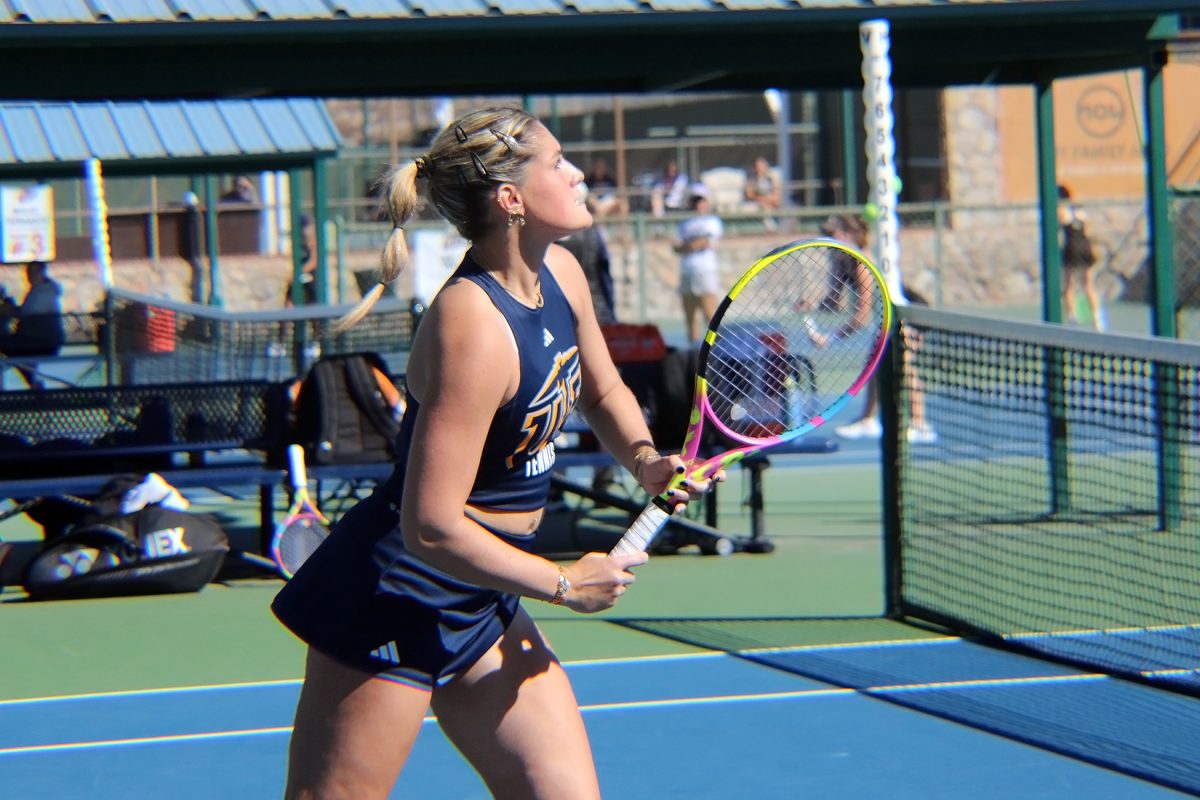 Junior Candice Bernier runs to the ball in hopes of striking and scoring a point against the Weber State Wildcats.