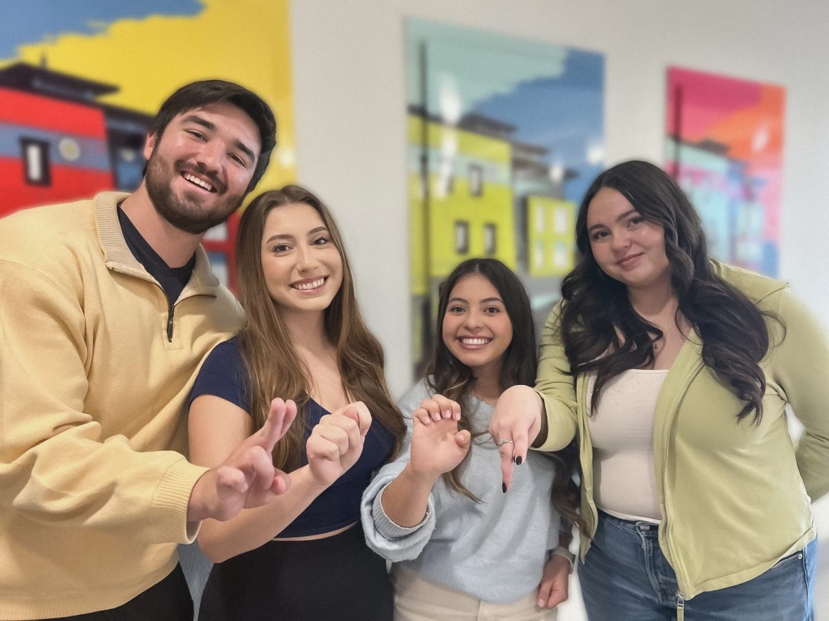 Members of the organization Everyone Signs demonstrate the American Sign Language (ASL) alphabet spelling out "UTEP."