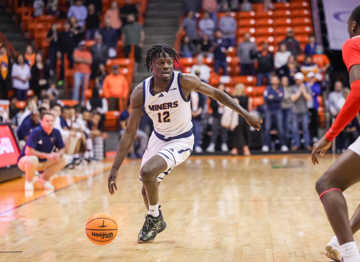 Junior guard Ahamad Bynum looks to make a play as he attempts to surpass a WKU Player.